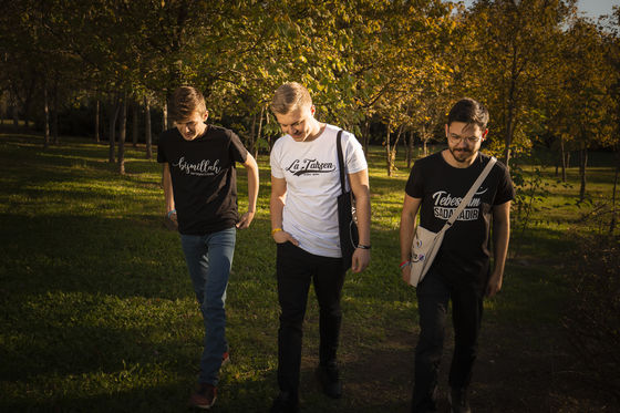 Group of young people walking wearing Nuve Store t-shirts.